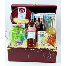 Gift basket with wine, tea, and snacks in a decorative box