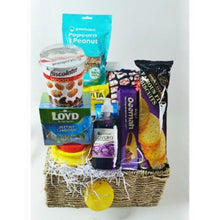 gift basket with treats arranged in it against a white background