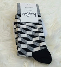 Black, white, and gray patterned socks with a visible brand label on a white fluffy surface.