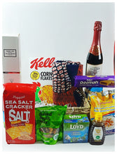 A gift basket containing various food items and a fragrance diffuser.