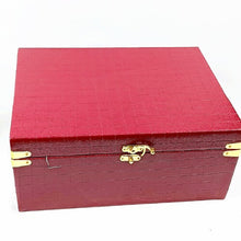 Red textured Leather Gift box with gold accents on a white background