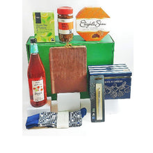 Gift box displayed on a white background. With Premuim biscuits, Green tea, sparkling Fruit presse, a pair of Mens Socks by Ted Baker and a Parker pen