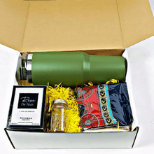 The silken Sip & Scent Lux's Hamper by Ral Gifts & Hampers. The gift box features a multi colored print silk scarf, A green quencher cup, A bottle of Gold office clips and a bottle of Rose de Nuit Perfume 100ml.
