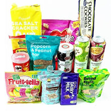 Assorted snack items including cookies, crackers, popcorn, and fruit bars on a white background