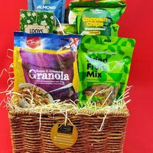 Basket of granola and snack mix packets on a red background