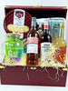 Gift basket with wine, tea, and snacks in a decorative box