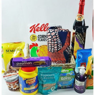 A gift basket containing various food items including cereal, dates, and snacks, with a decorative scarf added on top.
