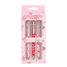 Set of three ballpoint pens in a pink packaging with strawberry and bow designs.