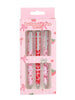 Set of three ballpoint pens in a pink packaging with strawberry and bow designs.