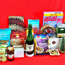 Unwrapped Christmas hamper contents including sparkling drink, Kellogg’s cereal, granola, tea, jam, cashews, popcorn bar and festive treats