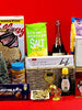 Assorted items including a laptop stand, snacks, and a bottle on a red background