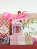  Pink & red themed gift box set containing a pink floral mug, a pink and white checkered towel, a pink knitted blanket tied with a pink ribbon, a box of Bonds More Than Pizza sweets, a pack of 3 Pens, and a floral prayer journal that reads 'My prayer journal, 21 days of prayers, praise & devotion 