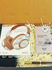 S black gift box filled with box filler, a Sony Bass headphone, a pair of cufflinks, a mahogany pen and a bar of artisan chocolate bar by loom chocolates

