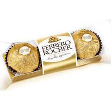 A box of Ferrero Rocher chocolate showing three round golden-wrapped chocolates in a clear-fronted gold box with a white and gold label.