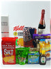 A gift basket containing various food items and a fragrance diffuser.