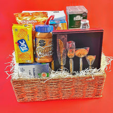 gift basket with food and a cutlery set against a red background