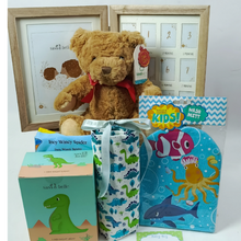 A beautiful display of hamper basket contents. Teddy, photo frame, Trex night light,  Bath mitt , Handkerchief and a flannel