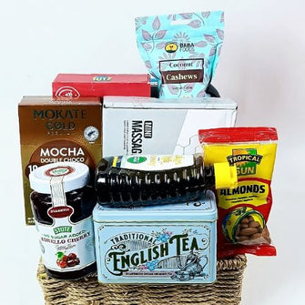 Gift basket with assorted snacks and tea on a white background