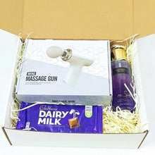 The scarlet relief box. A white and purple themed gift box containing a mini massage gub set, A victoria secrets body splash and a bar of dairy milk 110g chocolate. 