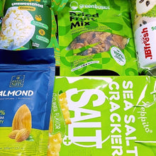 Assorted snack packages including a dried fruit mix, almond nuts, and sea salt crackers.