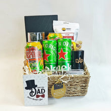 The Silent Harbour Hamper, a luxury Father's Day gift basket featuring Desperados and Heineken beers, chili cashews, a heavy-duty beer tankard, custom notebook, mahogany pen, bottle opener, date fruits, and Father's Day card in a handcrafted woven basket.