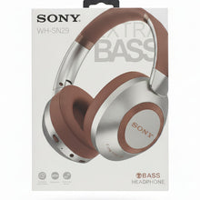Sony headphones packaging held by a hand with multiple boxes in the background