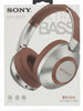Sony headphones packaging held by a hand with multiple boxes in the background