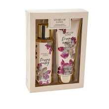 A boxed fragrance gift set containing a body lotion bottle and a body cream tube, both labeled 'STORY OF LOVE Dreamy Waiting' with pink floral graphics, presented in a cream-colored box on a white background.