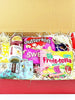 Open box containing various snacks and drinks including Butterkist, Swee, and Fruit-tella products.
