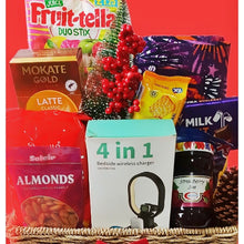 Assorted items including a '4 in 1' bedside wireless charger, snacks, and a small Christmas tree on a red background.