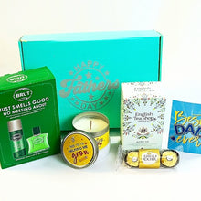 The Gentle Giant Father's Day gift box featuring grooming essentials, organic tea, premium chocolates, a scented candle, and heartfelt appreciation cards arranged in a luxury gift box.