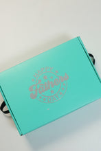 Turquoise Fathers Day gift box with a black ribbon on a white background 