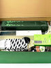 Green gift box with tea packages , A parker pen, Baileys Irish cream, Fragrance diffuser and a zebra-patterned sock.