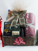 Christmas gift basket filled with gourmet treats and a fabric, towel and leatherette notepad.Wrapped up in tulle netting. 