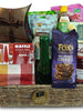 Gift basket with a variety of items including cookies, tea, and kitchen towels.