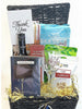 Gift basket with various items including a wine glass, snacks, and a bottle of La Motta coffee on a white background.