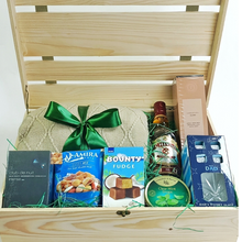 Luxury Father's Day gift crate in a natural wooden keepsake box featuring a knitted comfort item with green ribbon, premium mixed nuts, fudge chocolates, mint drops, Hareem Istanbul clove diffuser, whiskey glass, refreshments and gourmet treats for dads and father figures.