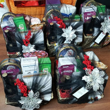 Gift basket wrapped in festive materials against a wooden background 