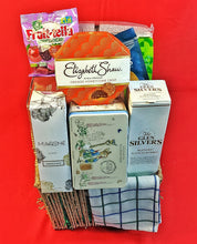 A premium packed collection of snacks and items including a box of Fruitella, Elizabeth Shaw orange honeycomb crisp, and Glen Silvers whisky on a red background.