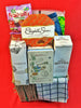 A premium packed collection of snacks and items including a box of Fruitella, Elizabeth Shaw orange honeycomb crisp, and Glen Silvers whisky on a red background.