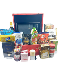 Luxury Gift box hamper filled with candles, Diffuser, nuts, drinks,perfumes all around it against a white background.