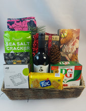 Christmas Hamper Basket filled with Premium ĝifts such as a wax fabric, a fragrance Diffuser,  TUC biscuits,  An Ashtray , wine and a Baylis bath & body gift set